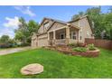 Well-manicured lawn and beautiful flower beds add to the curb appeal of this delightful home at 1831 Ashford Cir, Longmont, CO 80504