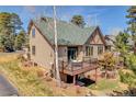 Back exterior featuring a small deck and a grassy area at 1294 Red Lodge Dr, Evergreen, CO 80439