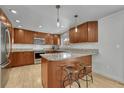 Spacious kitchen with wooden cabinets, granite countertops, stainless steel appliances, and an island with seating at 5080 S Boston St, Greenwood Village, CO 80111