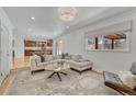 Open-concept living room with a view of the kitchen, a large window, and comfortable seating at 5080 S Boston St, Greenwood Village, CO 80111