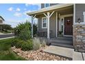 Inviting front porch with stone accents and landscaping at 1303 Yellow Granite Way, Monument, CO 80132