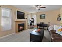 Living room with fireplace, comfortable seating, and a cat tree at 1303 Yellow Granite Way, Monument, CO 80132