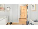 Light and bright entryway featuring a knotty alder wood door and hardwood floors at 277 S Gilpin St, Denver, CO 80209