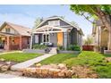 Charming home with a craftsman-style front exterior and a well-manicured lawn and stone landscaping at 277 S Gilpin St, Denver, CO 80209