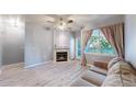 Bright living room with a cozy fireplace, ceiling fan, balcony access and neutral tones at 5320 Allison St # 202, Arvada, CO 80002