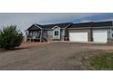 View of this single Gathering home with a two-car garage, gravel driveway, and tasteful light blue siding at 14545 Barksdaly Way, Keenesburg, CO 80643