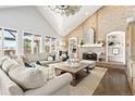 Bright living room featuring a brick fireplace, built-in shelves, and large windows at 3749 White Bay Dr, Highlands Ranch, CO 80126