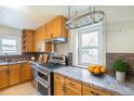 Well-appointed kitchen with stainless steel appliances, granite countertops, and ample storage at 3790 W 54Th Ave, Denver, CO 80221