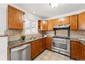 Well-maintained kitchen with stainless steel appliances, granite counters, and ample storage space at 1335 S Holly St, Denver, CO 80222