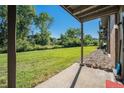 Back porch with view of expansive green lawn and beautiful trees at 309 E Highline Cir # 102, Centennial, CO 80122