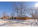 Cute bungalow with a snow-covered yard and wooden fence at 3470 W 42Nd Ave, Denver, CO 80211