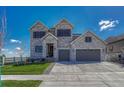 Charming two-story home with stone accents, a well-manicured lawn, and a spacious driveway at 6860 S Yantley Ct, Aurora, CO 80016