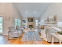 Bright living room with high ceilings, hardwood floors, and a cozy fireplace at 8167 S Wabash Ct, Centennial, CO 80112
