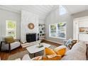 Cozy living room showcasing the stone fireplace and ample natural light at 2645 S Xanadu Way # C, Aurora, CO 80014