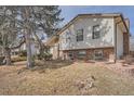 A split level home with brick facade, manicured lawn and minimal shrubs in a well established neighborhood at 15341 E Arkansas Pl, Aurora, CO 80017