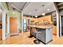 Modern kitchen with stainless steel appliances, a center island, and wooden cabinets at 1860 N Washington St # 212, Denver, CO 80203