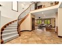 Elegant foyer with a grand staircase, iron railings, high ceilings, and an open view to the living room, creating a welcoming ambiance at 3048 Starling Ct, Castle Rock, CO 80109