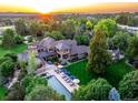 Expansive aerial view of a luxurious home with a pool, manicured lawn, and lush landscaping at 5 Random Rd, Cherry Hills Village, CO 80113