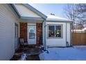 Brick front entry with a covered porch and a window at 1621 Flemming Dr, Longmont, CO 80501