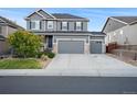 Two-story house with gray siding, stone accents, and a three-car garage at 7478 Oasis Dr, Castle Rock, CO 80108