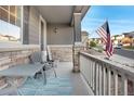 Front porch with seating area and American flag at 7478 Oasis Dr, Castle Rock, CO 80108