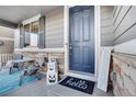 Inviting front porch with seating area and autumnal decorations at 7478 Oasis Dr, Castle Rock, CO 80108