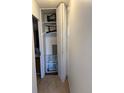 A folding door hides a storage closet with shelving on the interior at 795 S Alton Way # 11C, Denver, CO 80247