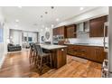 Modern kitchen with hardwood floors, stainless steel appliances, and an island at 250 Columbine St # 210, Denver, CO 80206