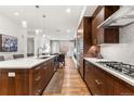 Modern kitchen with wood cabinets, quartz countertops, and stainless steel appliances at 250 Columbine St # 210, Denver, CO 80206