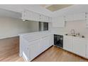 Open kitchen featuring a breakfast bar, white cabinets, and stainless steel appliances at 389 S Kalispell Way # C, Aurora, CO 80017