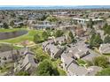 Aerial view of the community, showing landscaping, lake, and surrounding area at 13254 E Asbury Dr, Aurora, CO 80014