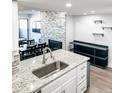 Modern kitchen with granite countertops, stainless steel sink, and an open layout at 17090 E Ford Dr # 209, Aurora, CO 80017