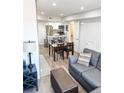 Open-concept living area with a modern kitchen, dining area, and comfortable seating at 17090 E Ford Dr # 209, Aurora, CO 80017