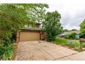 Two-story home featuring a driveway and a large, well-maintained front yard with mature trees at 18206 E Loyola Dr, Aurora, CO 80013