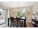 Bright dining area with large windows and sliding door, adjacent to the kitchen at 9528 Pendio Ct, Highlands Ranch, CO 80126