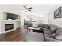 Inviting living room boasting hardwood floors, a fireplace, a comfortable gray sectional, and an open layout at 2209 Lupine Pl, Erie, CO 80516
