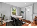 Bright dining area features a large window, stylish rug, and door to the outside at 3102 N Columbine St, Denver, CO 80205