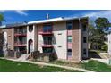 Exterior angle view of the multi-level residential home featuring balconies, brick, and stone at 12120 Melody Dr # 308, Westminster, CO 80234