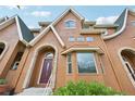 Stylish townhome showcases a unique architectural design with a prominent arched entrance and a copper bay window at 18173 E Saskatoon Pl, Parker, CO 80134
