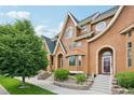 Inviting townhome exterior showcases unique architectural features, complemented by well-maintained landscaping at 18173 E Saskatoon Pl, Parker, CO 80134