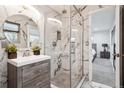 Modern bathroom featuring a marble tiled shower with glass enclosure and a sleek vanity at 7488 S Lafayette E Cir, Centennial, CO 80122