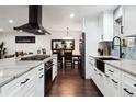 Open-concept kitchen featuring white cabinetry, marble countertops, and stainless steel appliances at 7488 S Lafayette E Cir, Centennial, CO 80122