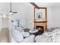 Comfortable living room features a tiled fireplace, neutral decor, and hardwood flooring at 10836 W Evans Ave # 29, Lakewood, CO 80227