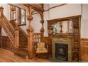 Charming space with ornate wood fireplace, a cozy chair, wood floors, and decorative trim at 131 N Sherman St, Denver, CO 80203