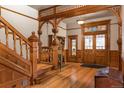 Elegant foyer featuring wood trim staircase, hardwood floors, stained glass, and detailed archway at 131 N Sherman St, Denver, CO 80203