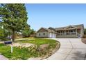 Charming single Gathering home with a welcoming front porch, a basketball hoop, and spacious front yard at 815 Meadow Ln, Palmer Lake, CO 80133
