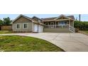 Charming ranch-style home with a welcoming front porch, two car garage and a spacious driveway at 815 Meadow Ln, Palmer Lake, CO 80133