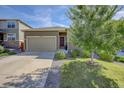 Home featuring a well-manicured lawn, concrete driveway, and attached two-car garage at 4238 S Netherland Cir, Aurora, CO 80013