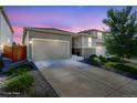 Charming home featuring a two-car garage, well-maintained landscaping, and neutral exterior paint at 4238 S Netherland Cir, Aurora, CO 80013