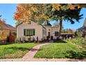 Charming home with a lush front yard, brick walkway with fall foliage at 1275 Birch St, Denver, CO 80220